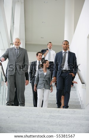 Business people in suit coming down stairs