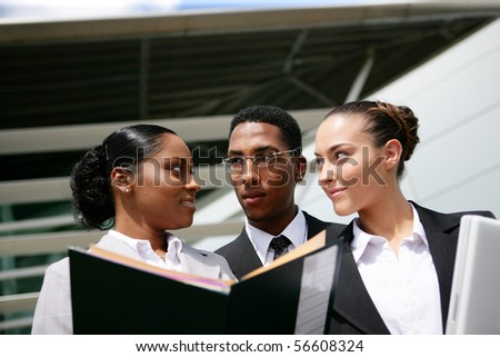 Portrait of young business people in suit holding documents