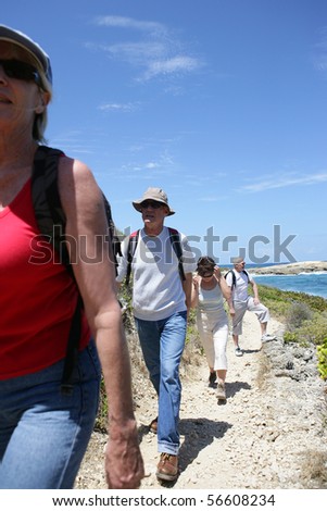 Senior group hiking at the seafront