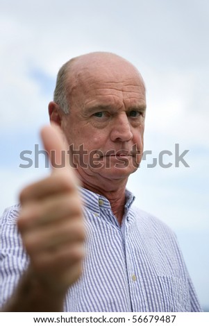 Portrait of a senior man with thumb up