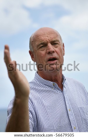 Portrait of a senior man raising a hand