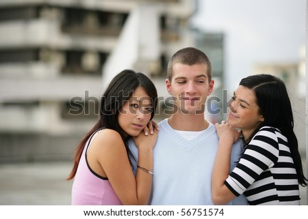 Young man with two young woman