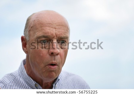 Portrait of a senior man astonished
