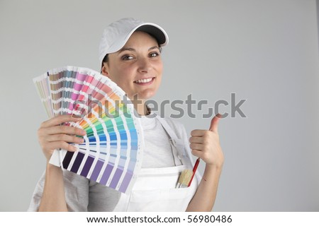 Portrait of a woman painter with swatches of colors on white background
