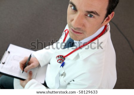 Doctor filling out medical files