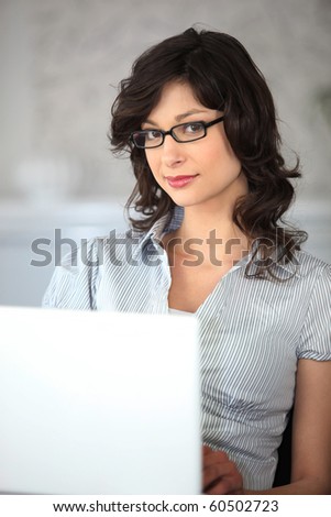 Portrait of a woman in front of laptop computer