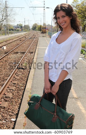 Young woman waiting for the train on the platform