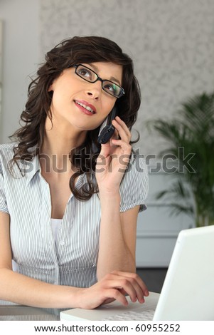 Portrait of a woman phoning in office