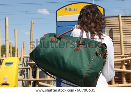 Young woman buying a transport ticket