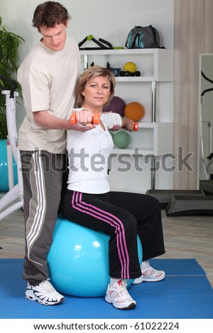 Senior woman with sports trainer