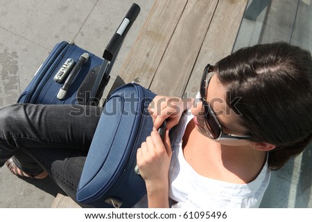 Portrait of a young woman with suitcase