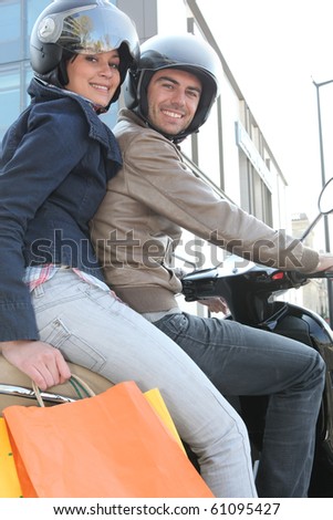 Couple strolling on a motorcycle in town