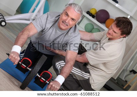 Senior man and sports trainer