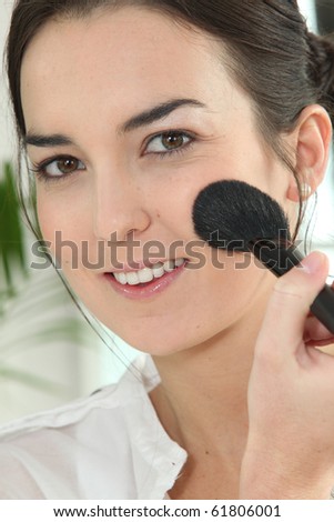 Portrait of a woman making up