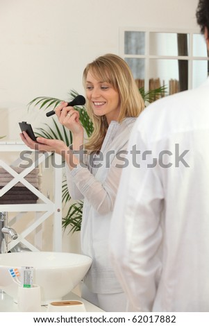 Portrait of a woman making up with a brush