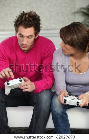Young man and young woman playing video game