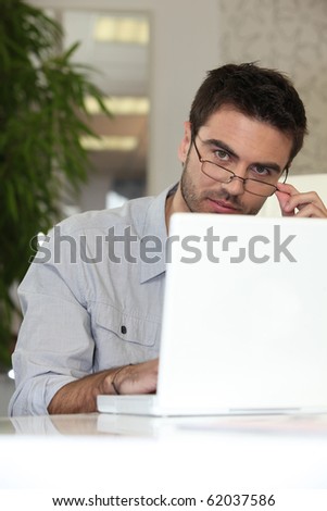 Relaxed man in front of a laptop computer