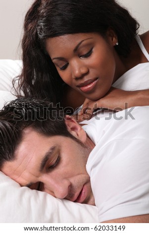 Woman laid near a sleeping man