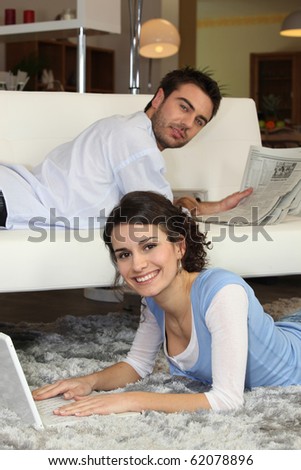Couple relaxing in front of laptop computer