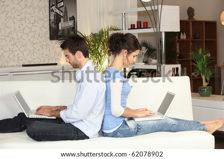 Young couple in front of computer at home