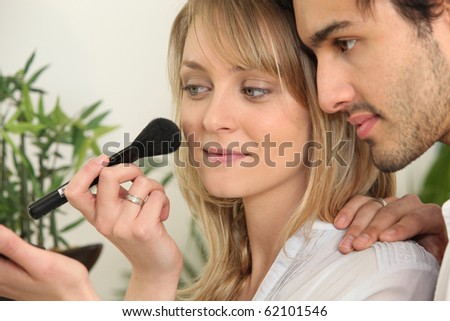 Portrait of a woman making up with a brush