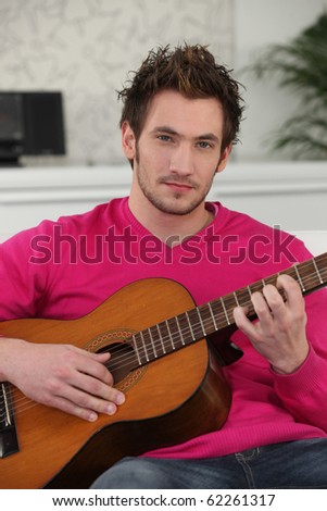 Portrait of a young man playing the guitar