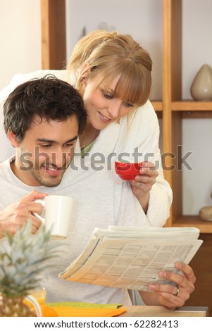 Portrait of a couple reading newspaper