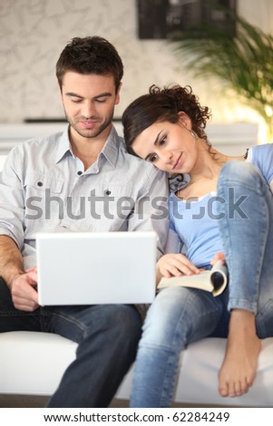 Young couple in front of computer at home