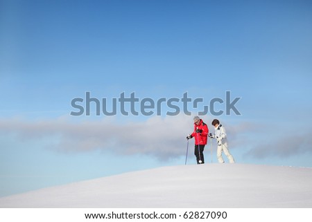Senior man and woman walking in snow