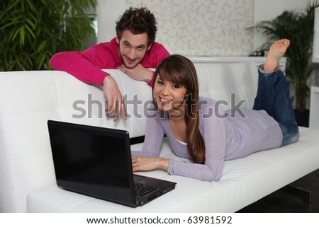 Man and woman in front of a laptop computer