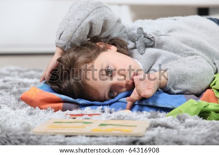 stock photo Portrait of a little girl sucking her thumb