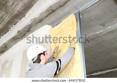 Worker laying insulation