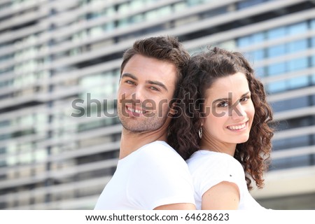 Portrait of a smiling couple back to back