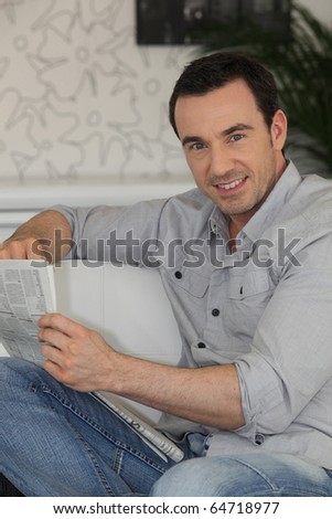 Portrait of a man reading newspaper