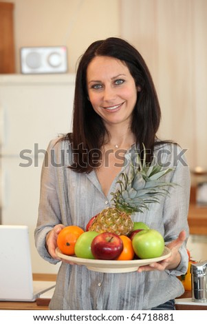 Portrait of woman with fruits tray