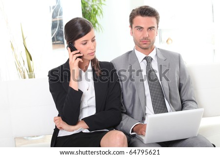Businessman and businesswoman in front of a laptop computer