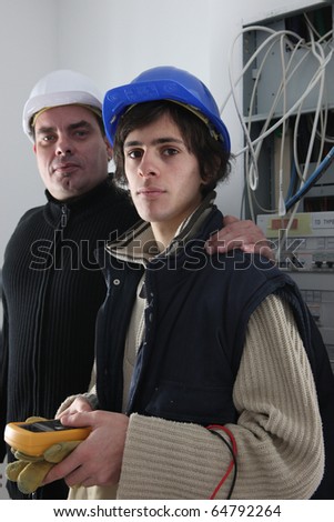 stock photo : Electrician training an apprentice