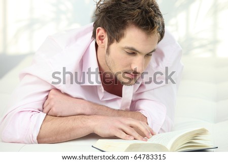Relaxed man in front of a book