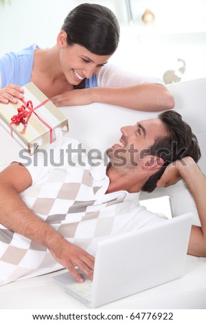 Young woman offering a gift to her friend