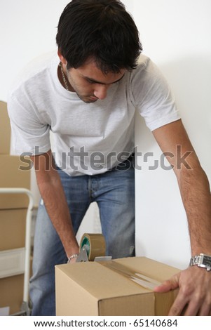 Young man packing cartons