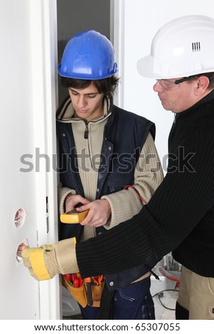 stock photo : Electrician training an apprentice