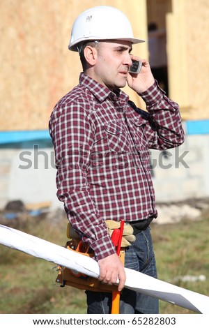 Worker on phone on a construction site