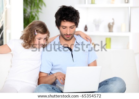 Man and Girl in front of a laptop computer