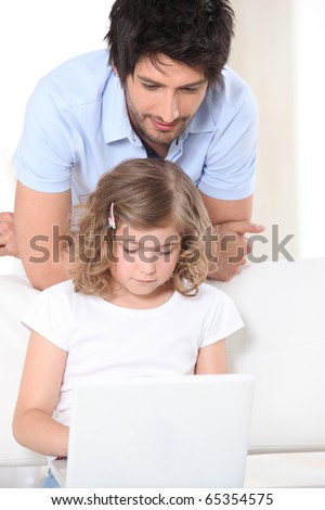 Man and Girl in front of a laptop computer