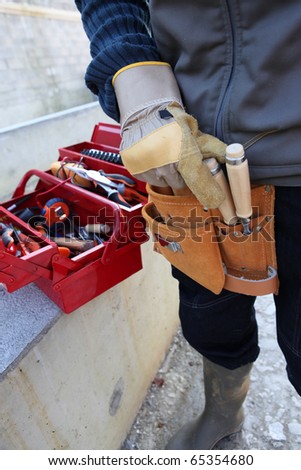 Worker with tool box and tool belt