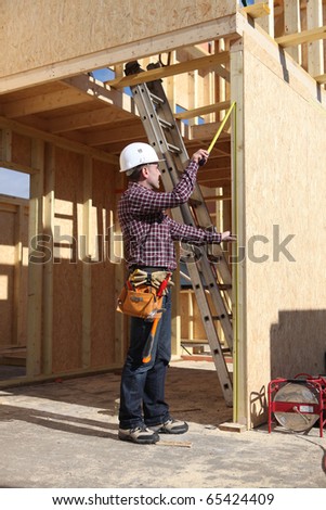 Laborer working on a house under construction