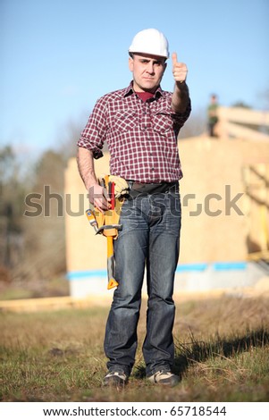 Worker with thumb up on a construction site