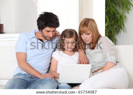 Family in front of a laptop computer