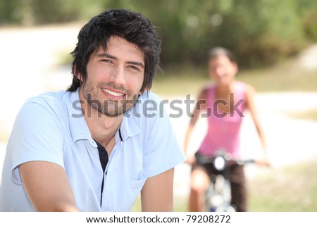 man riding bike outdoors and blurry background and woman riding bike