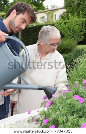 Son watering the flowers.